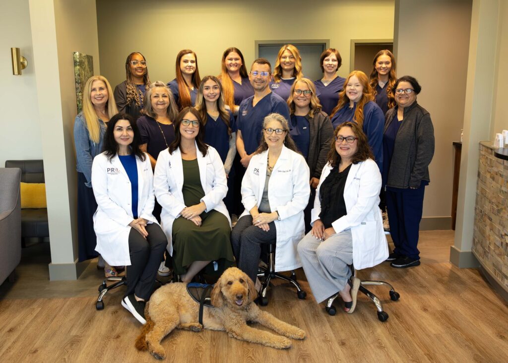 The Premier Rheumatology of Oklahoma team with Fergus, the practice therapy dog